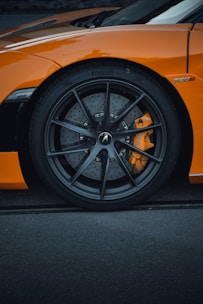 a close up of the front wheel of a sports car