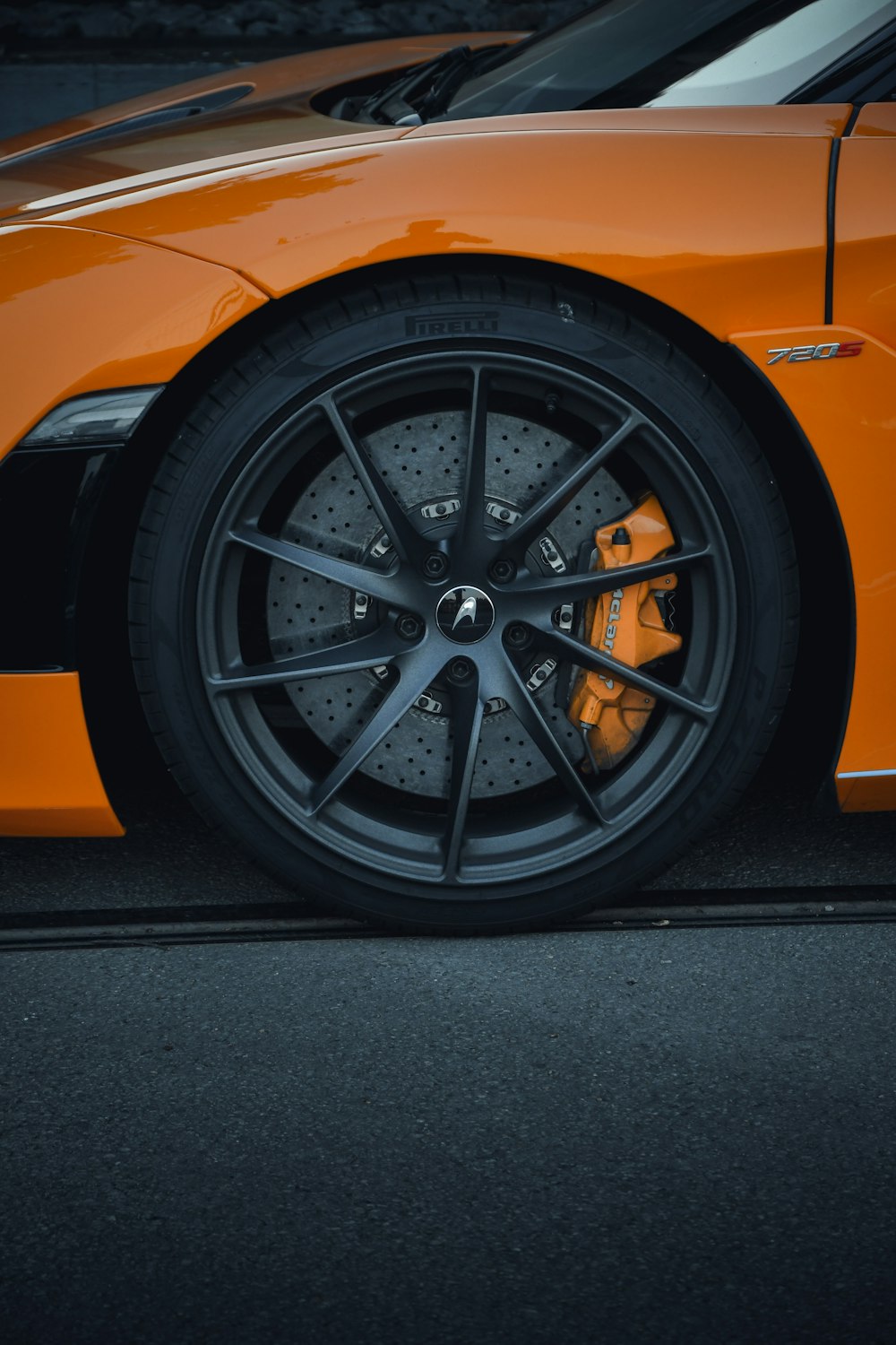 a close up of the front wheel of a sports car