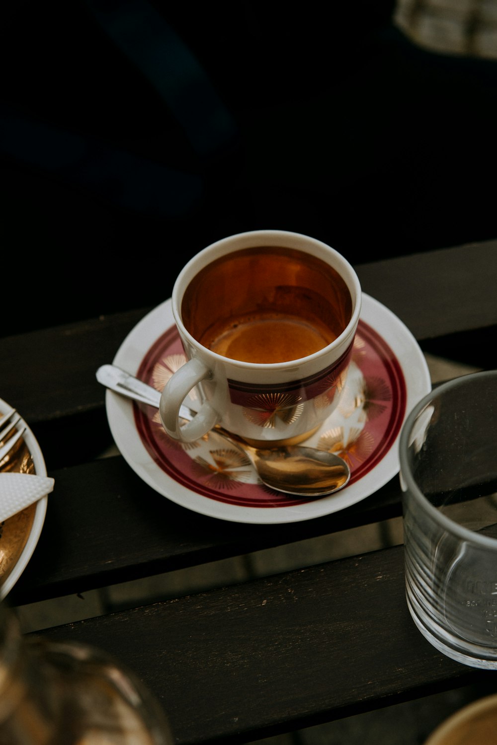 a cup of tea sits on a saucer on a table