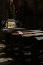 Interior view of the church altar during a solemn liturgy with candles lit.