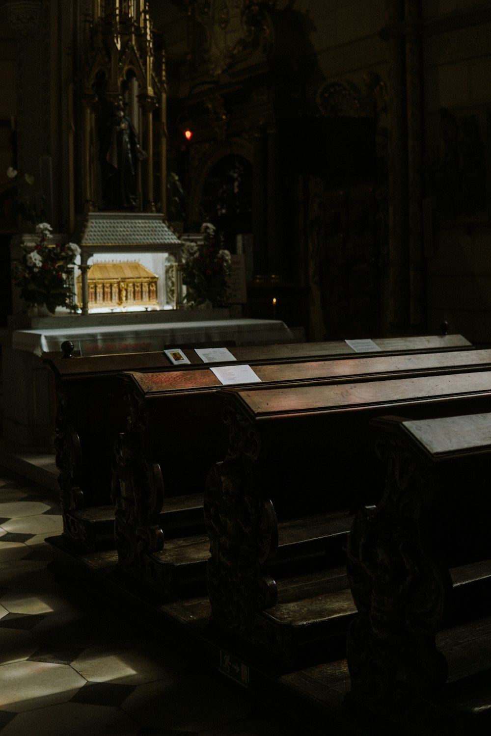 a row of pews in a church with a model of a church in the