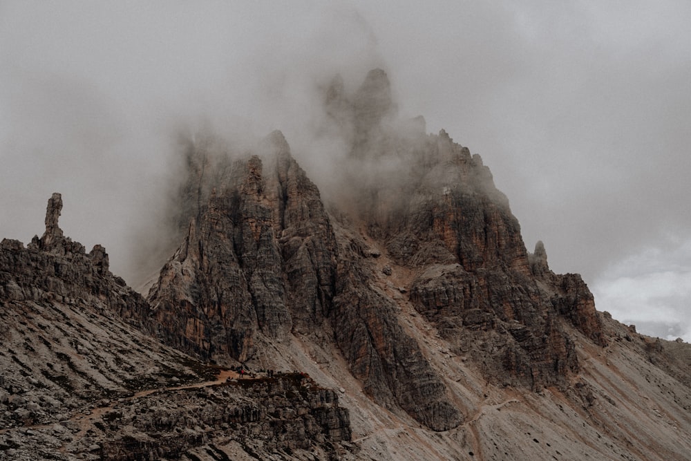 a very tall mountain covered in fog and clouds