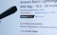 A webpage displaying a product listing for an Amazon Basics Lightweight Tripod. The product is currently unavailable, as indicated in red text. The listing includes a customer rating of five stars with 60,209 ratings, and it is marked as 'Amazon's Choice' for tripods. A black object, possibly part of the tripod, is visible in the foreground.