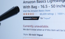 A webpage displaying a product listing for an Amazon Basics Lightweight Tripod. The product is currently unavailable, as indicated in red text. The listing includes a customer rating of five stars with 60,209 ratings, and it is marked as 'Amazon's Choice' for tripods. A black object, possibly part of the tripod, is visible in the foreground.