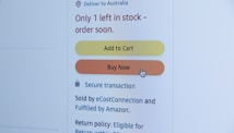 A screenshot of an online shopping webpage displaying a notification that only one item is left in stock and suggesting to order soon. There are two buttons, 'Add to Cart' in yellow and 'Buy Now' in orange, with a cursor hovering over the 'Buy Now' button. Additional text includes information about secure transactions and delivery options.