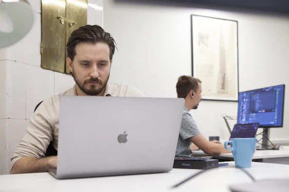 a man sitting in front of a laptop computer