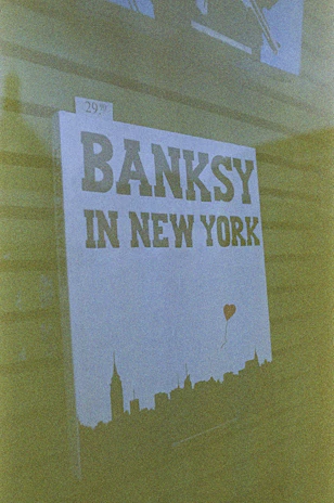 A gallery signboard listing exhibitions featuring Banksy’s works.
