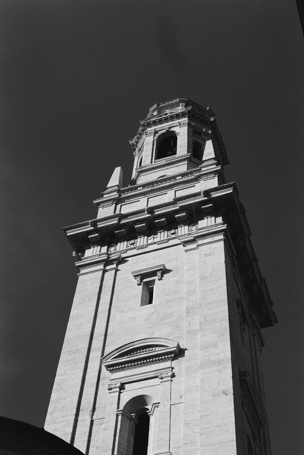 a black and white photo of a clock tower