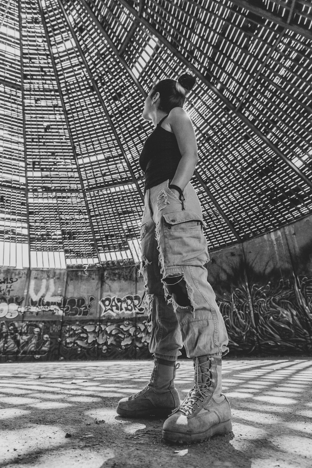 a man standing in front of a bamboo structure