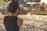 a woman taking a picture of a graffiti covered wall