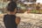 a woman taking a picture of a graffiti covered wall