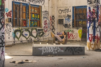 a man sitting on a box in an abandoned building