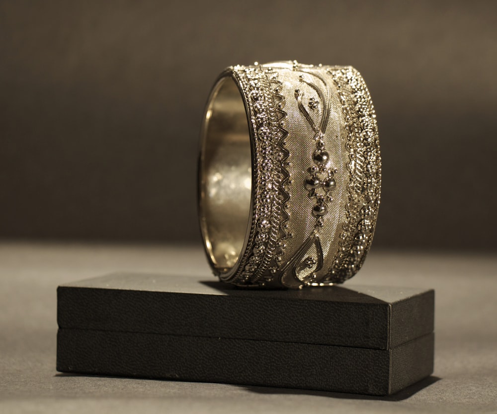 a gold ring with intricate designs on it