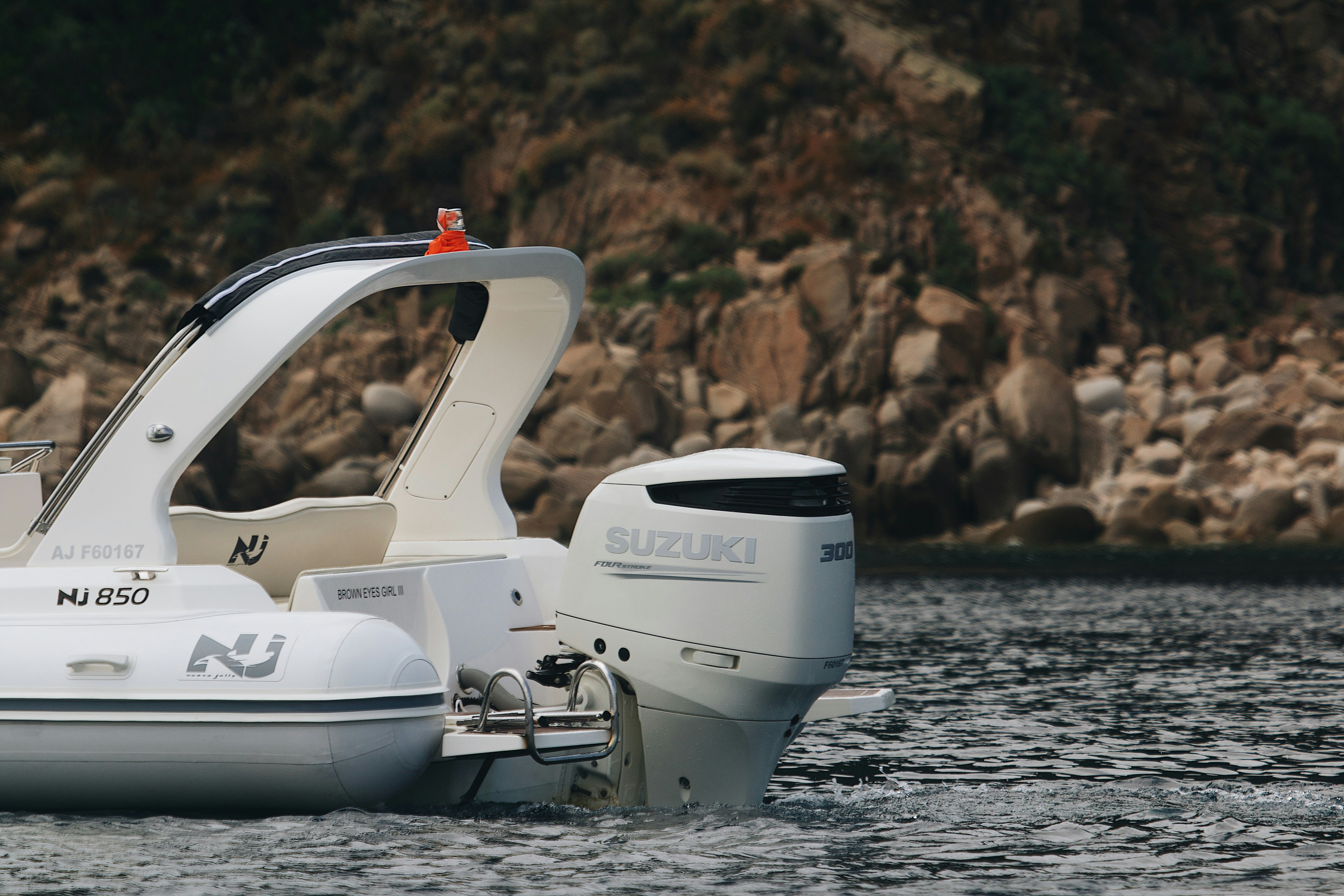 a white boat floating on top of a body of water
