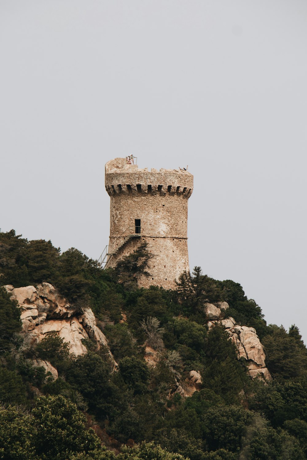 a tower on top of a mountain with a sky background