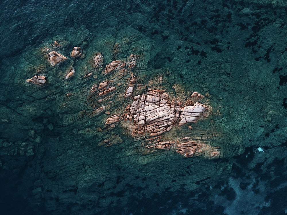 an aerial view of a rock formation in the ocean