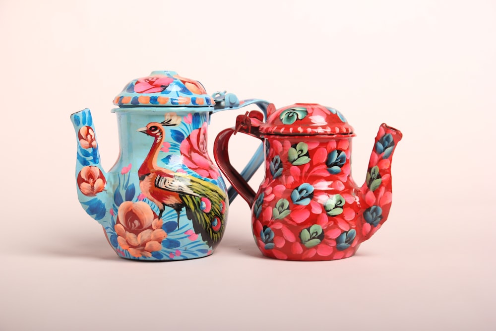 a teapot and a teapot with a bird painted on it