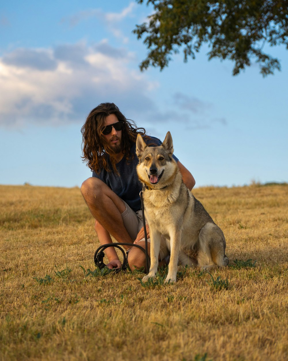 a man kneeling down next to a dog