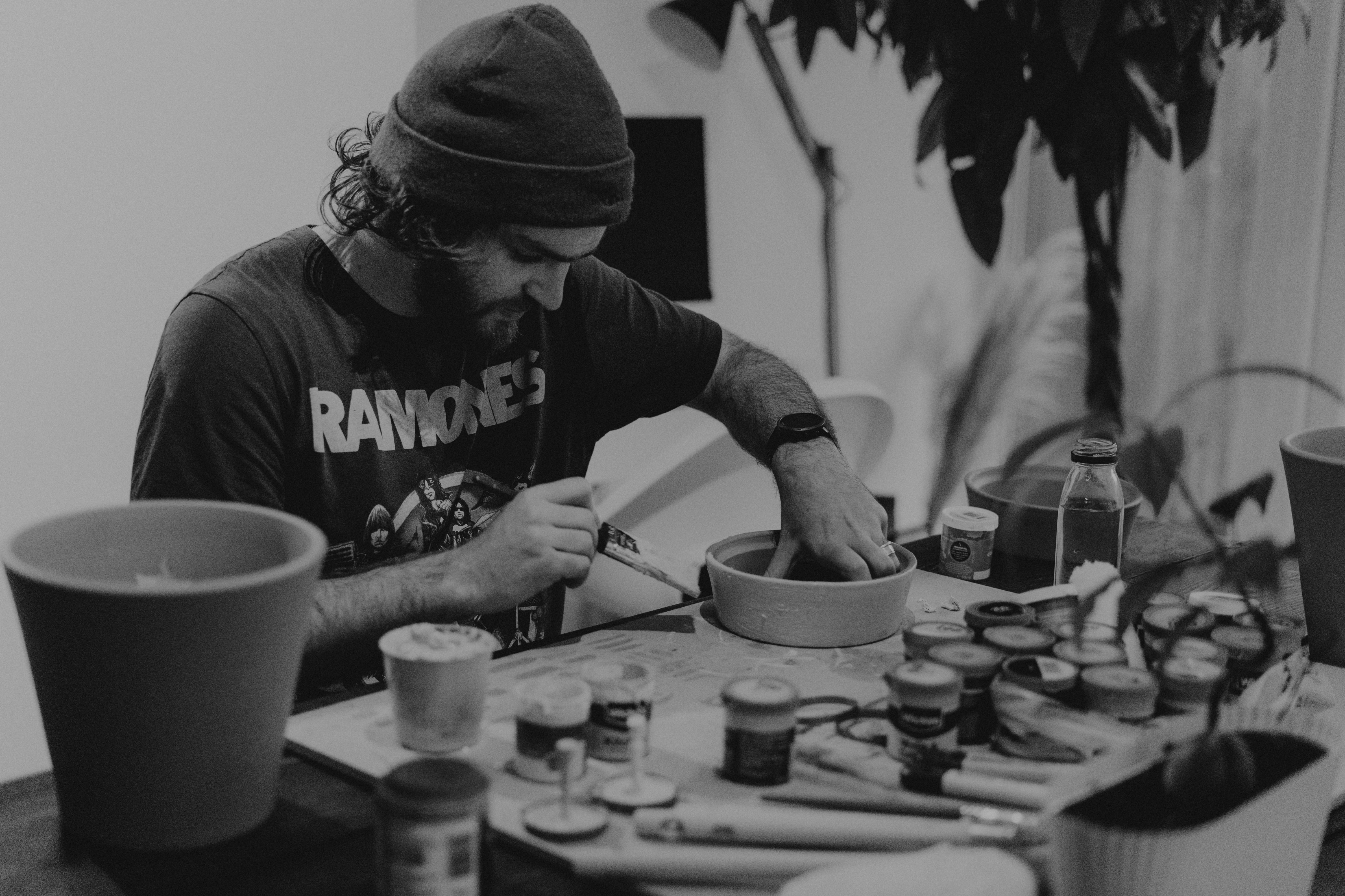 happy person learning a new skill like pottery or painting, surrounded by creativity