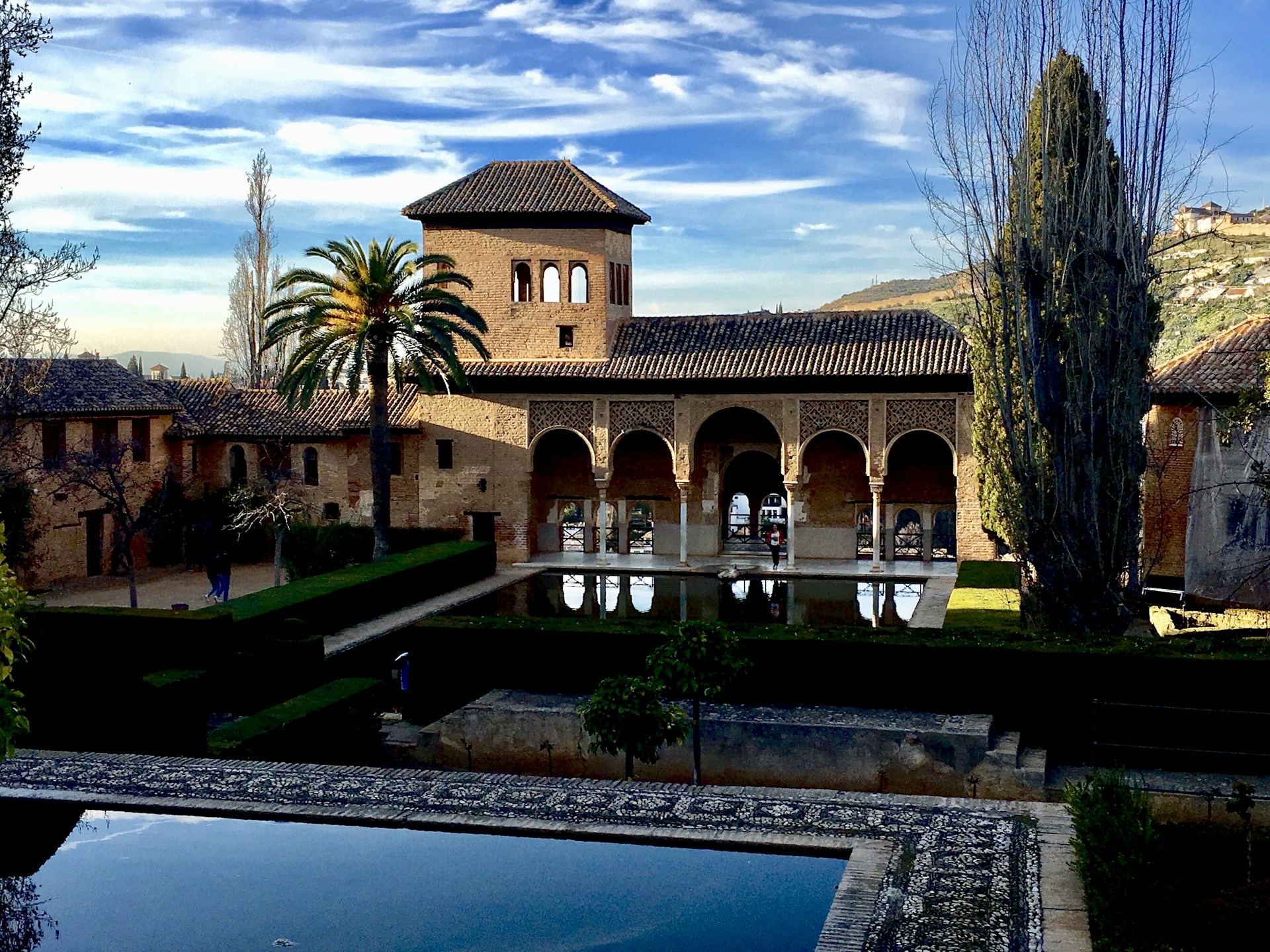 a large building with a pool in front of it