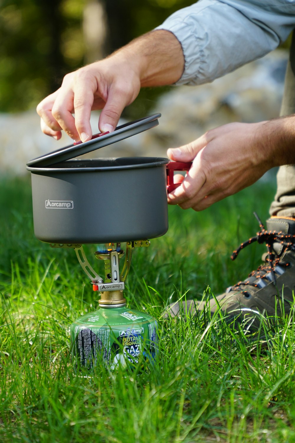 a man is putting something in a pot on the ground