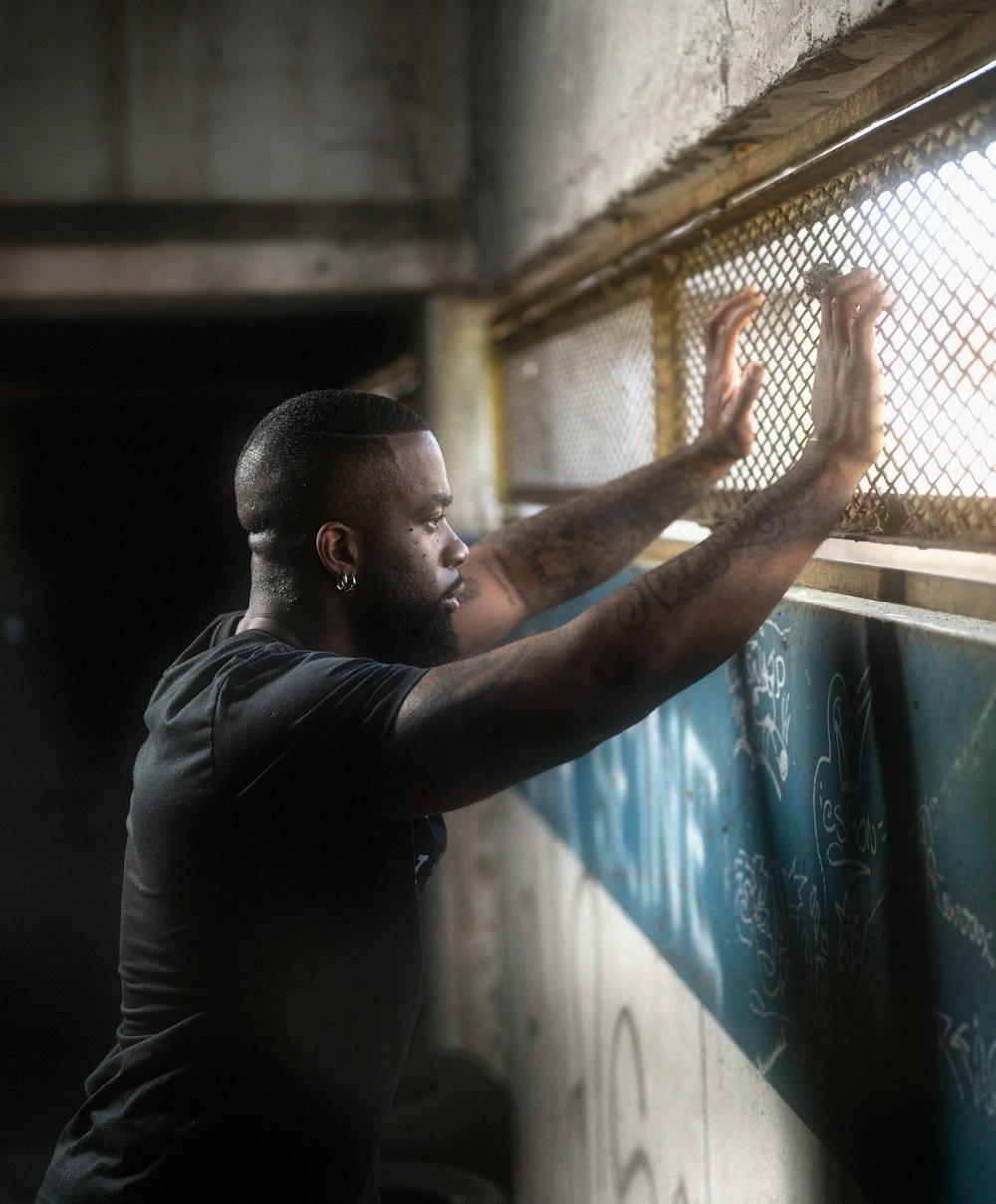 a man writing on a wall with a chalkboard