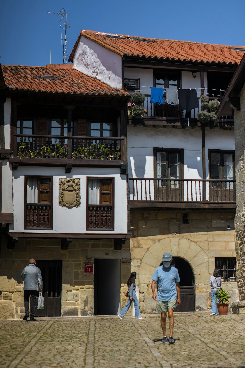 a group of people walking in front of a building