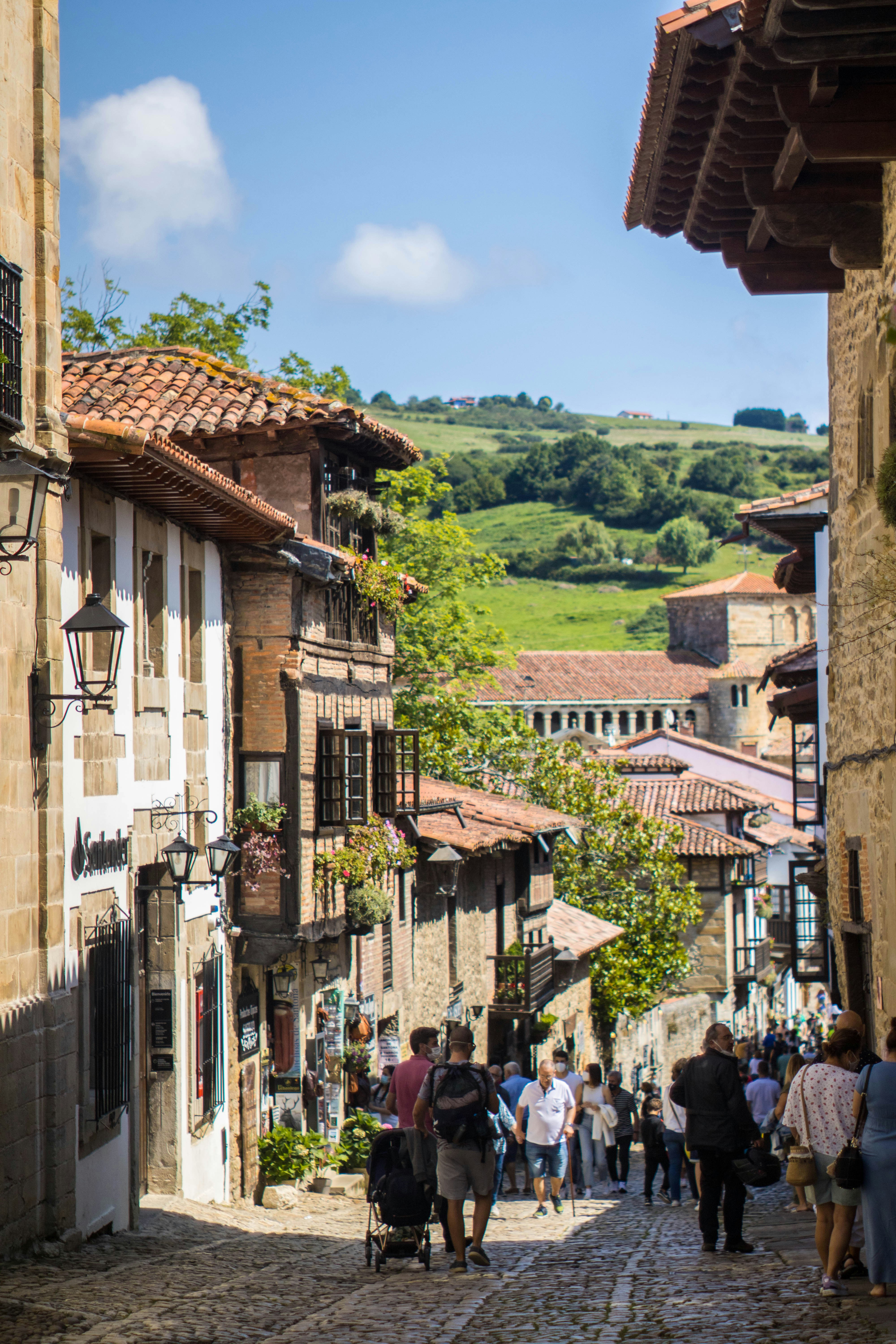a group of people walking down a cobblestone street