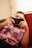 A person playing a mobile game on a couch, immersed in the vibrant screen.