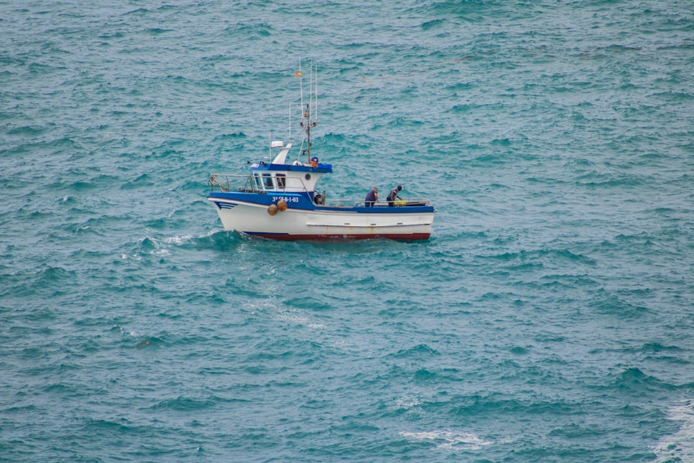 a small boat in the middle of the ocean