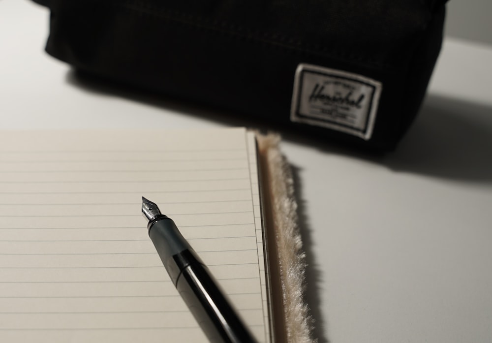 a pen sitting on top of a notebook