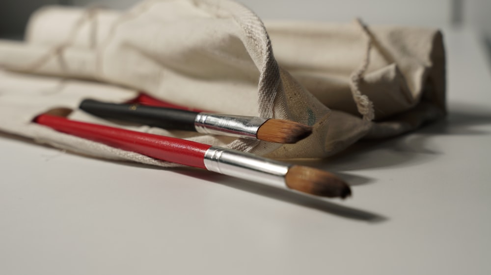 a pair of brushes sitting on top of a white table