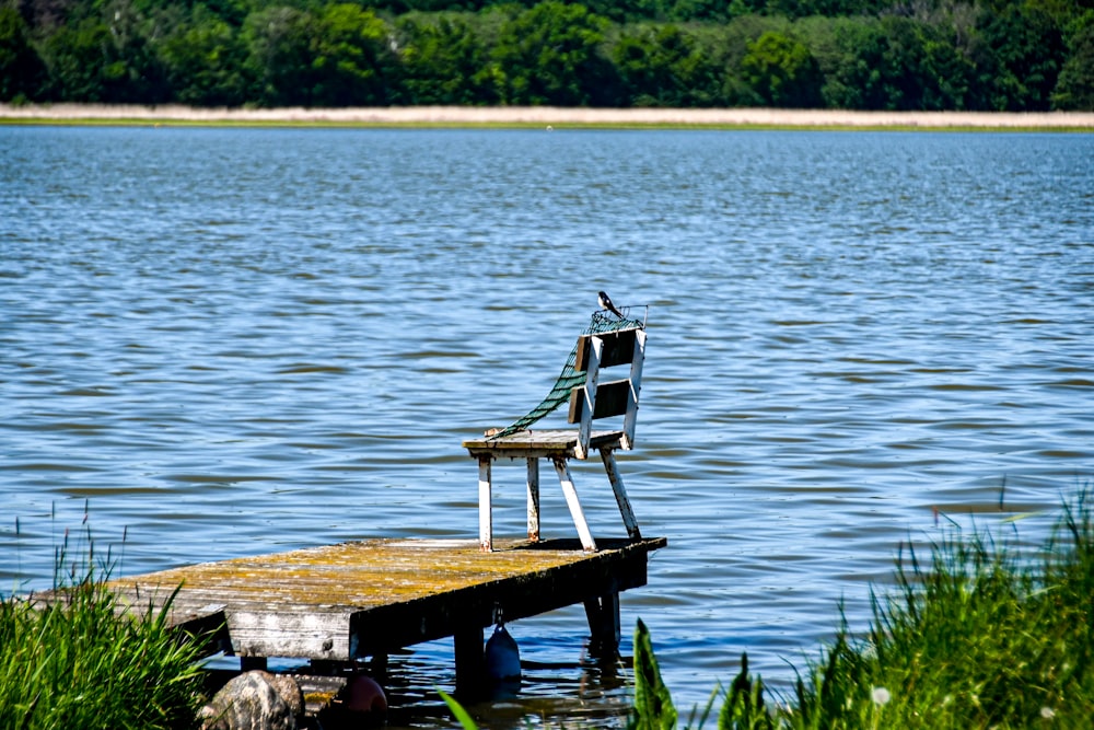 a chair sitting on top of a wooden dock