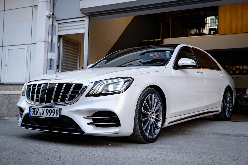 a white car parked in front of a garage