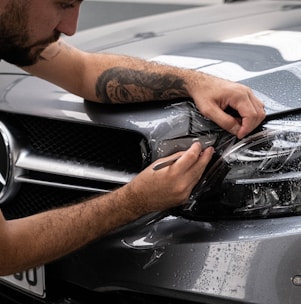 Paint Protection Film being applied to the bumper of a Mercedes
