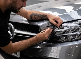 a man waxing the hood of a car
