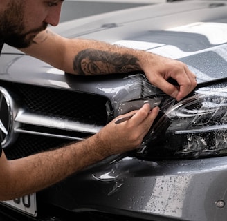a man waxing the hood of a car
