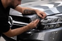 a man waxing the hood of a car