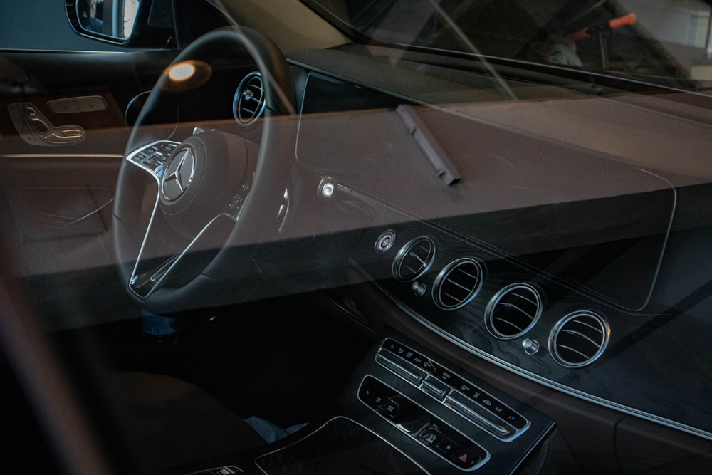 the inside of a car with a steering wheel and dashboard