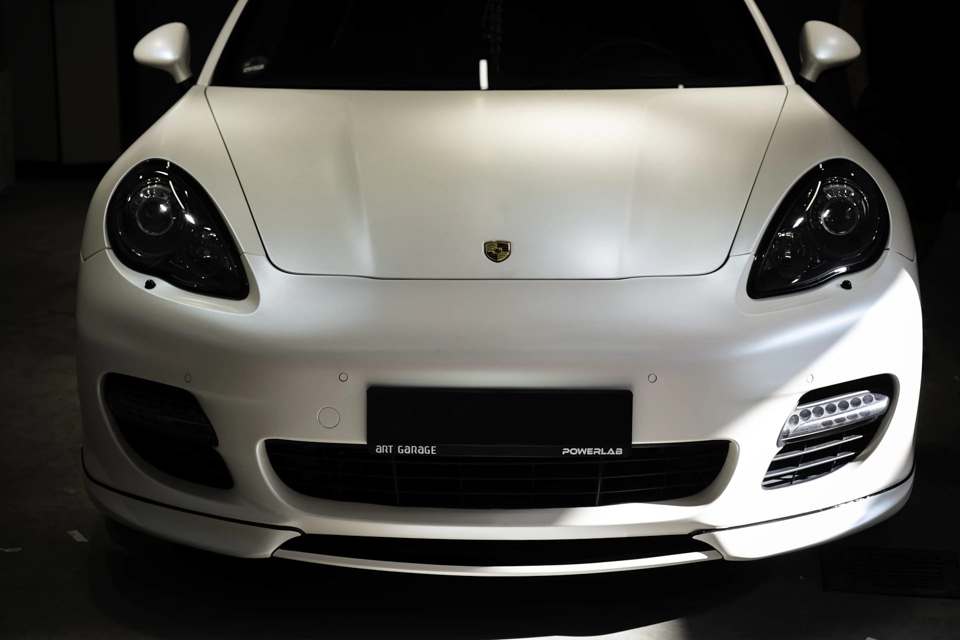 a white sports car parked in a garage