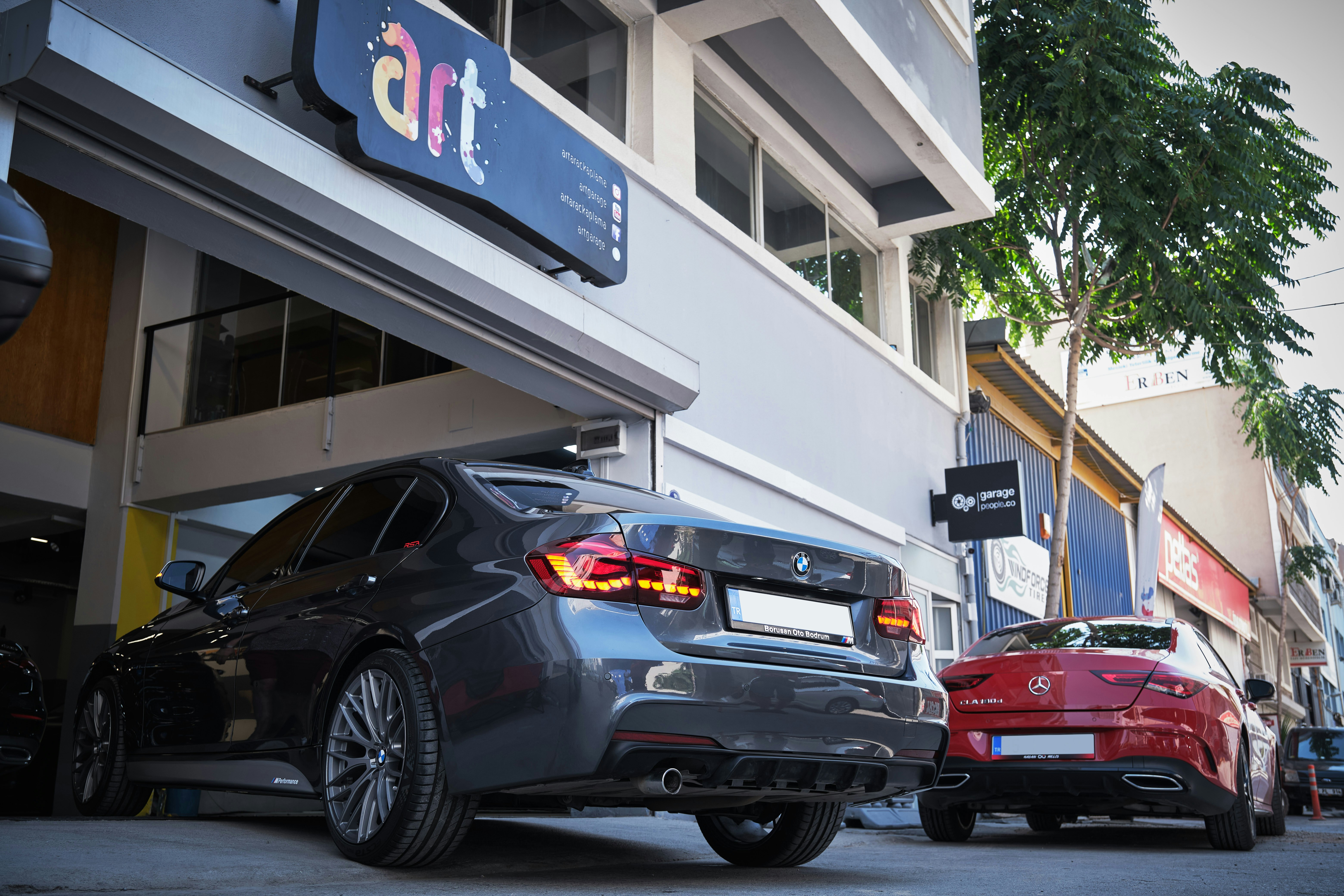 a couple of cars parked next to each other in front of a building