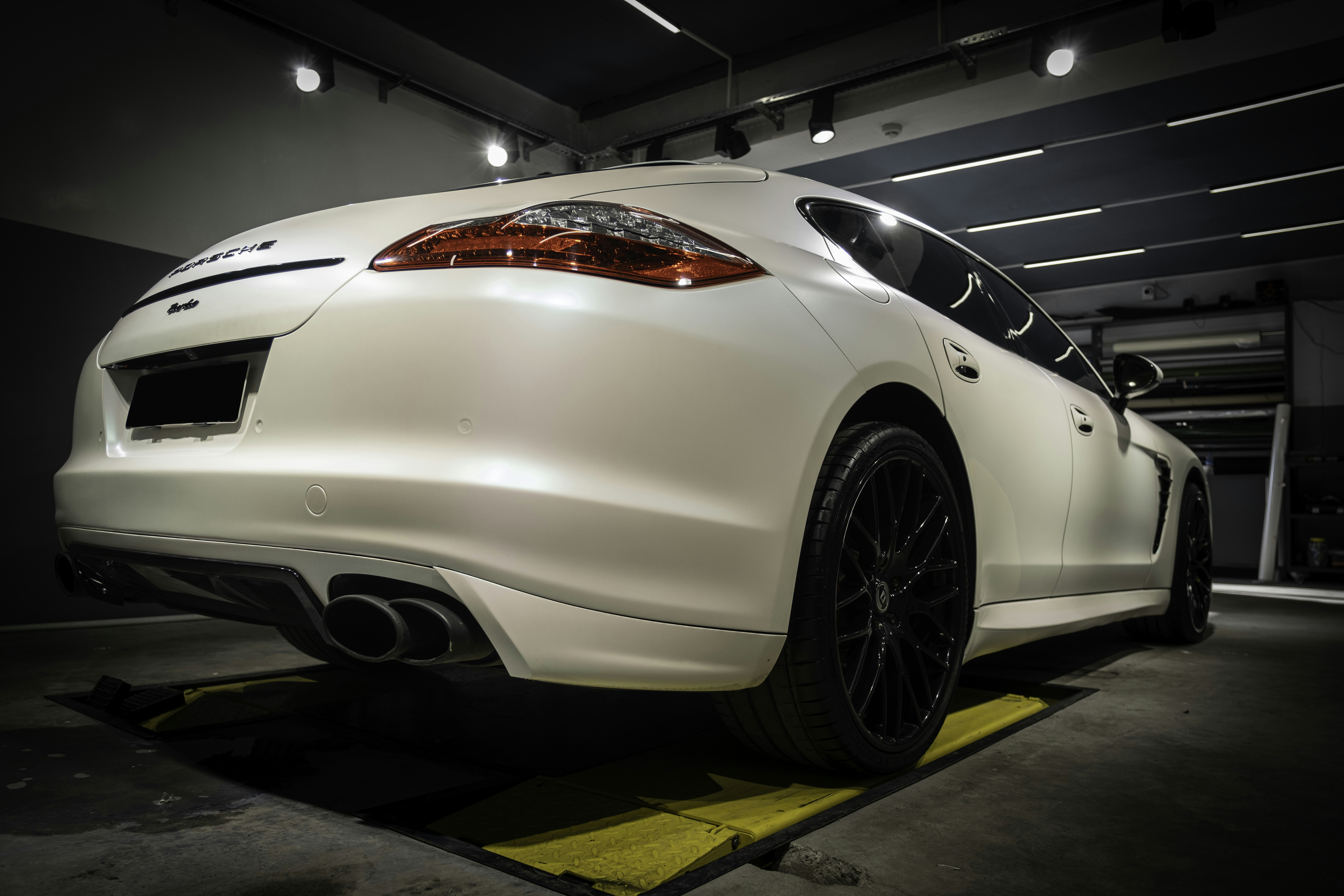 a white sports car parked in a garage