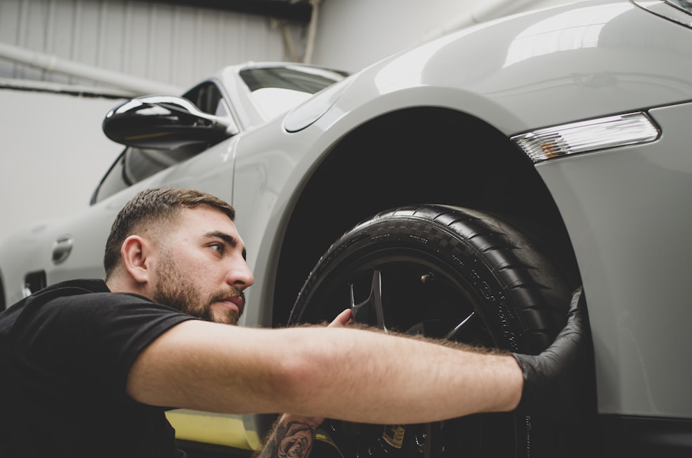 a man working on a car in a garage