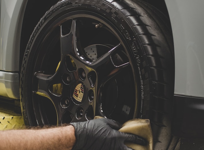 a man working on a tire on a car