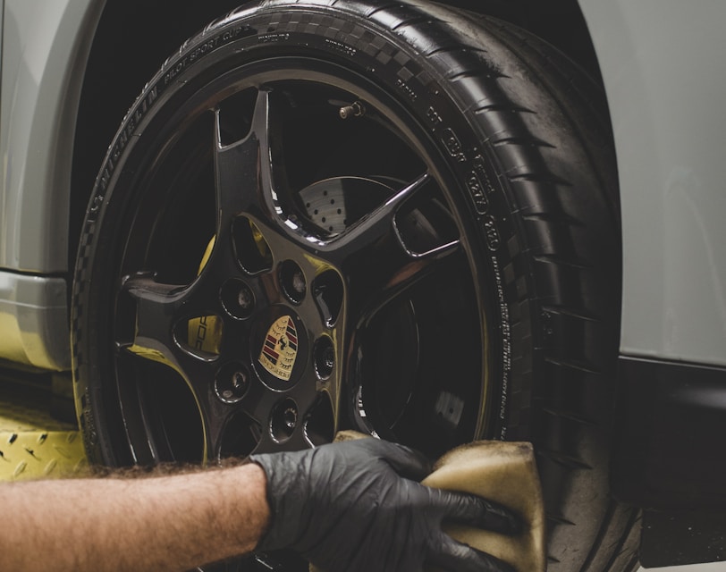 a man working on a tire on a car