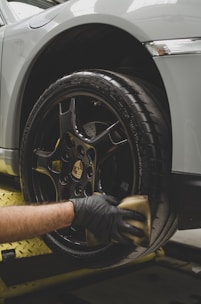 a man working on a tire on a car