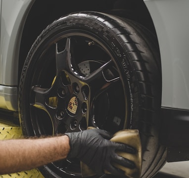 a man working on a tire on a car