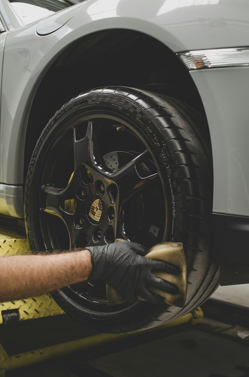 a man working on a tire on a car