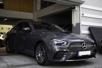 a car parked in a garage next to another car
