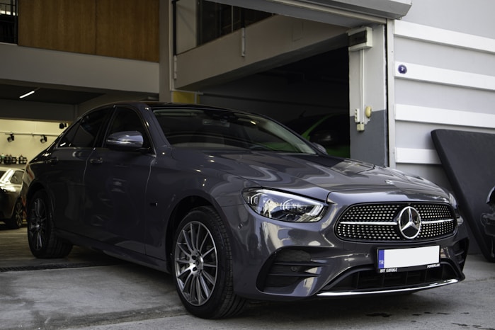 a car parked in a garage next to another car